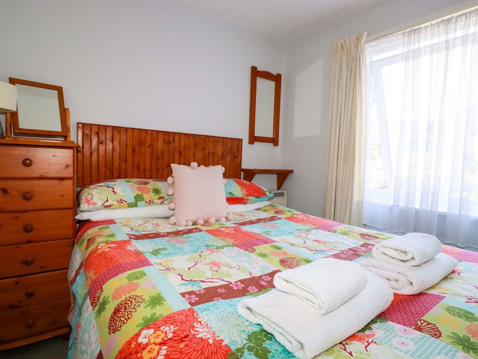 A bedroom with a bed and dresser at Chyancrowse in Penzance