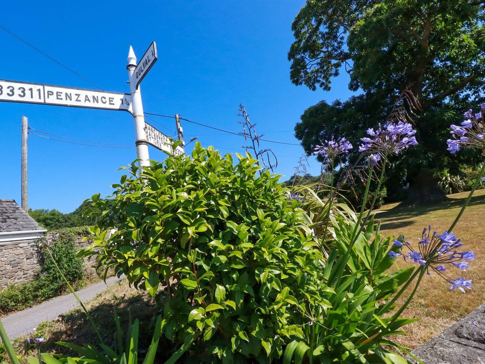 A road sign surrounded by greenery and flowers at Chyancrowse in Penzance
