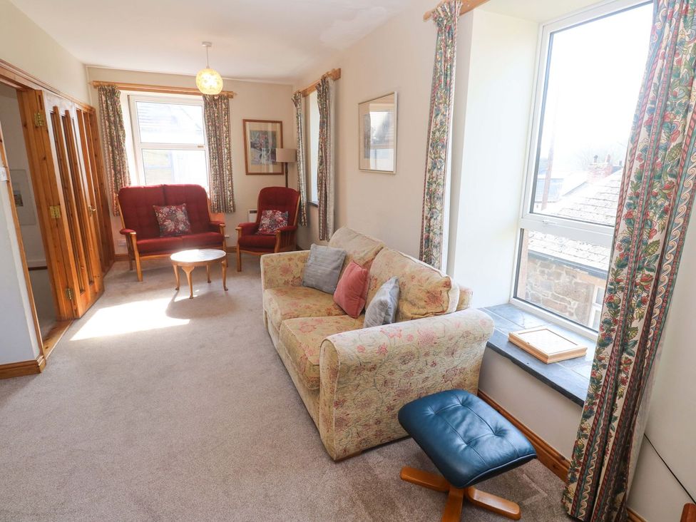 A living room with a sofa, armchairs and a coffee table at Chyandaunce in Penzance