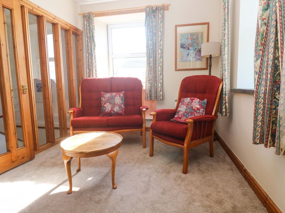 A sitting room with chairs and a table at Chyandaunce in Penzance