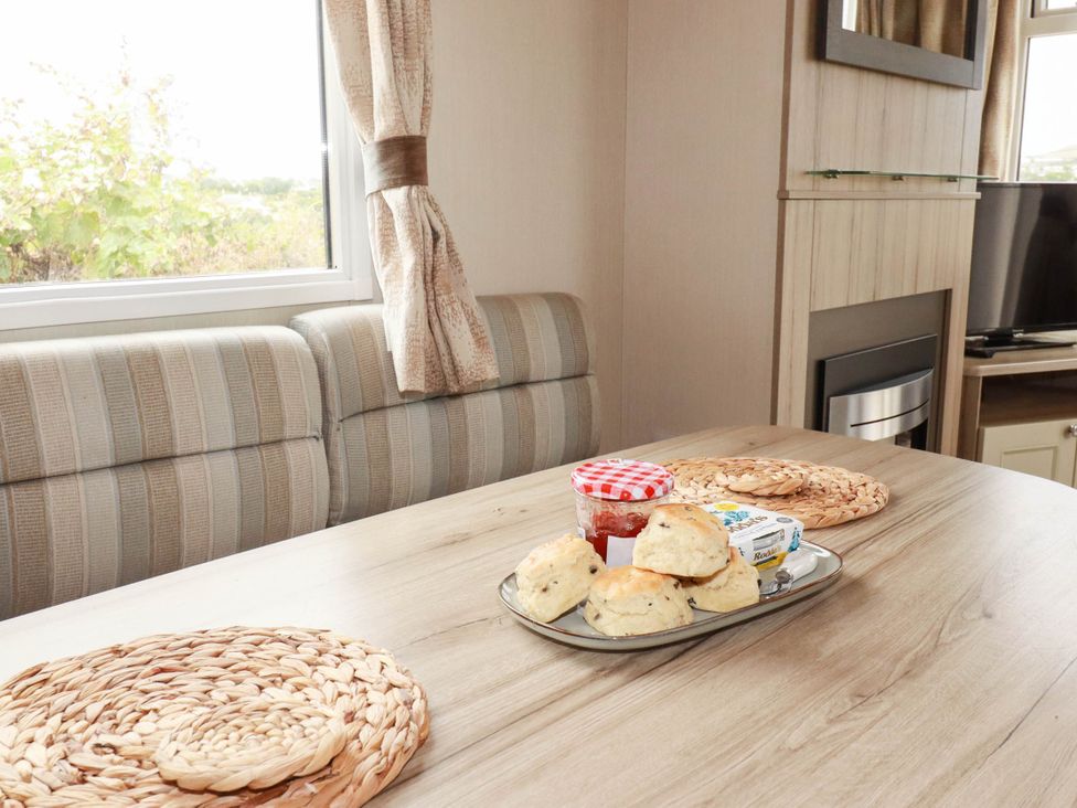 A dining room with a table set for tea at Roslenn in St Agnes