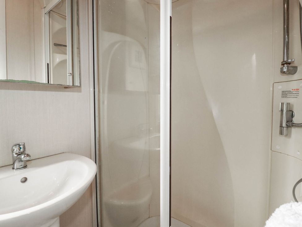 A bathroom with a sink and shower at Roslenn in St Agnes
