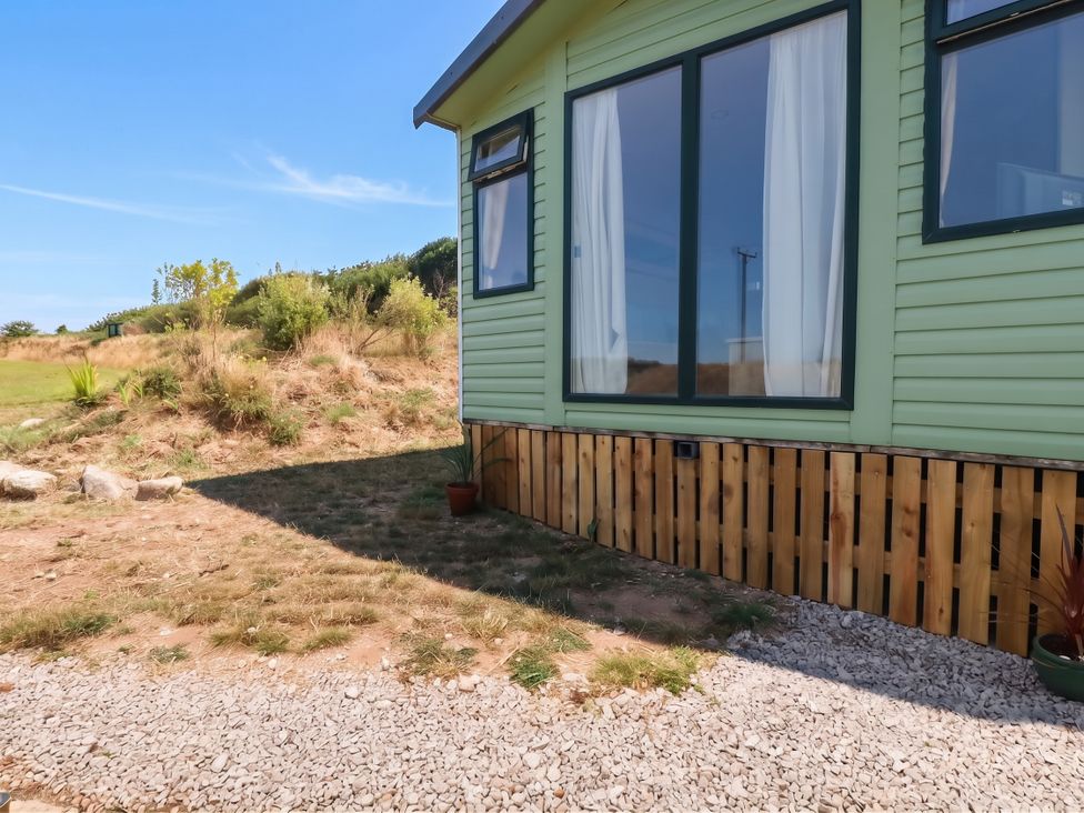 A house exterior with windows and gravel at Roslenn St Agnes