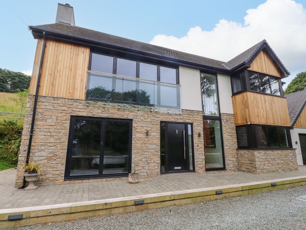 A modern house with stone and wood facade at The Barn at Bryn Eithin Colwyn Bay