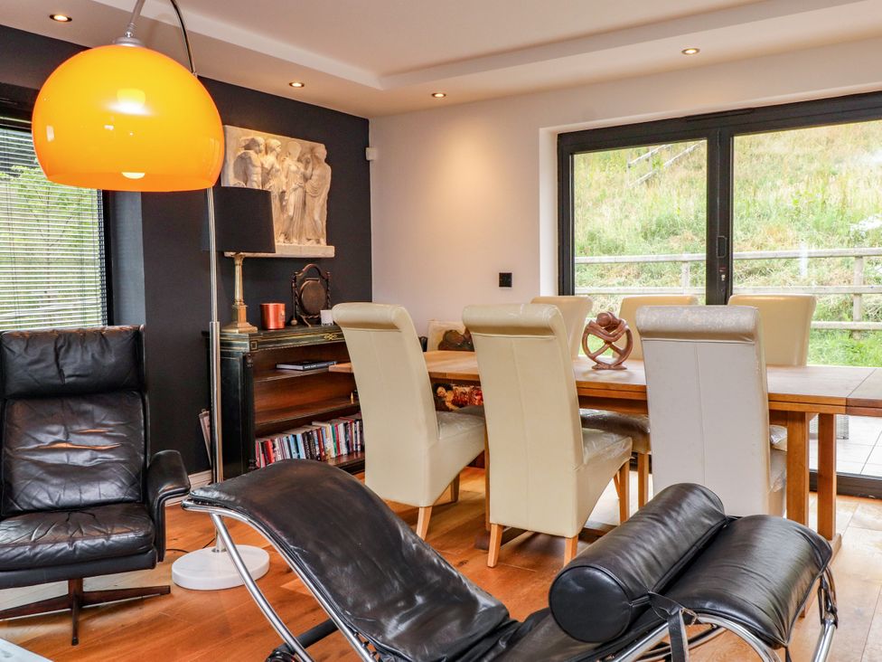 A dining room with a table and chairs at The Barn at Bryn Eithin Colwyn Bay