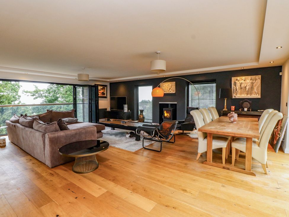 A living room with sofa and dining table at The Barn at Bryn Eithin Colwyn Bay