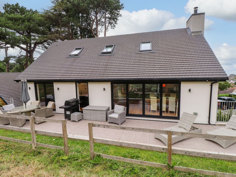 An outdoor area with seating and a grill at The Barn at Bryn Eithin Colwyn Bay