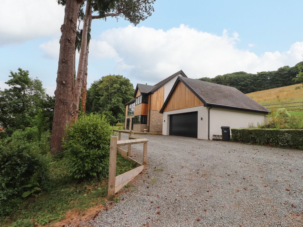 A house with a garage and driveway at The Barn at Bryn Eithin Colwyn Bay
