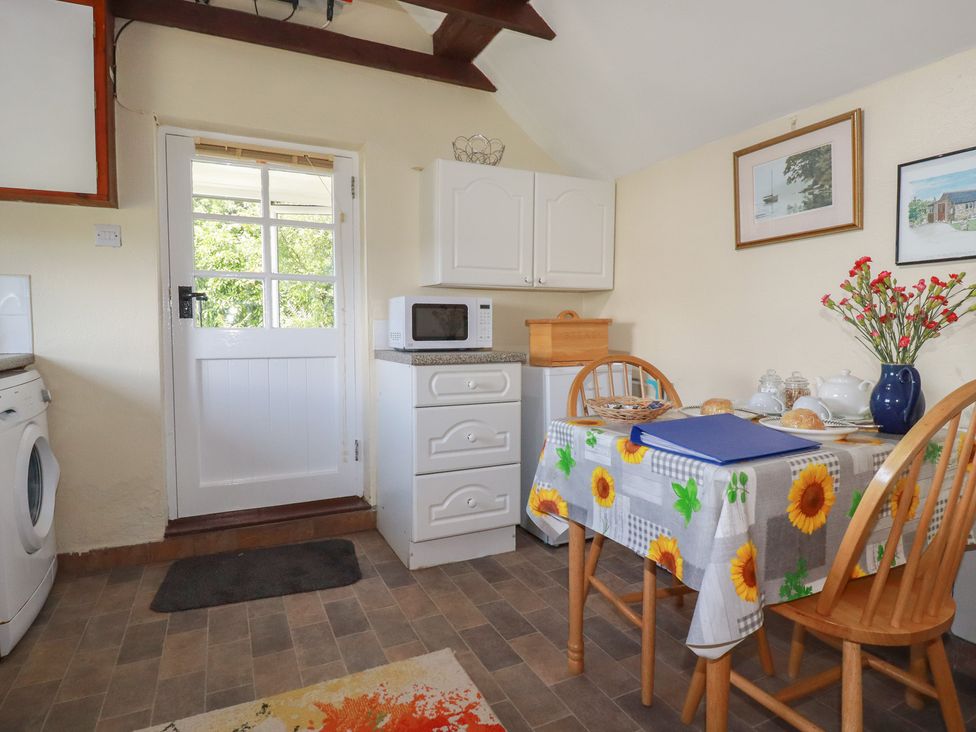 A kitchen with a table and chairs at Moorland Retreat in Bodmin