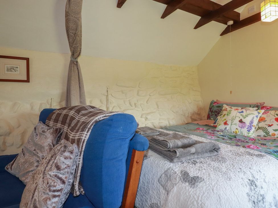 A bedroom with a bed and sofa at Moorland Retreat in Bodmin