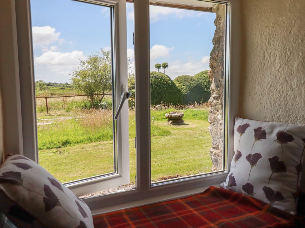 A view from a window with cushions and a table at Moorland Retreat in Bodmin