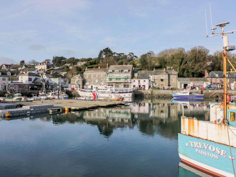 A harbor with boats and buildings reflected in the water at Moorland Retreat in St Breward