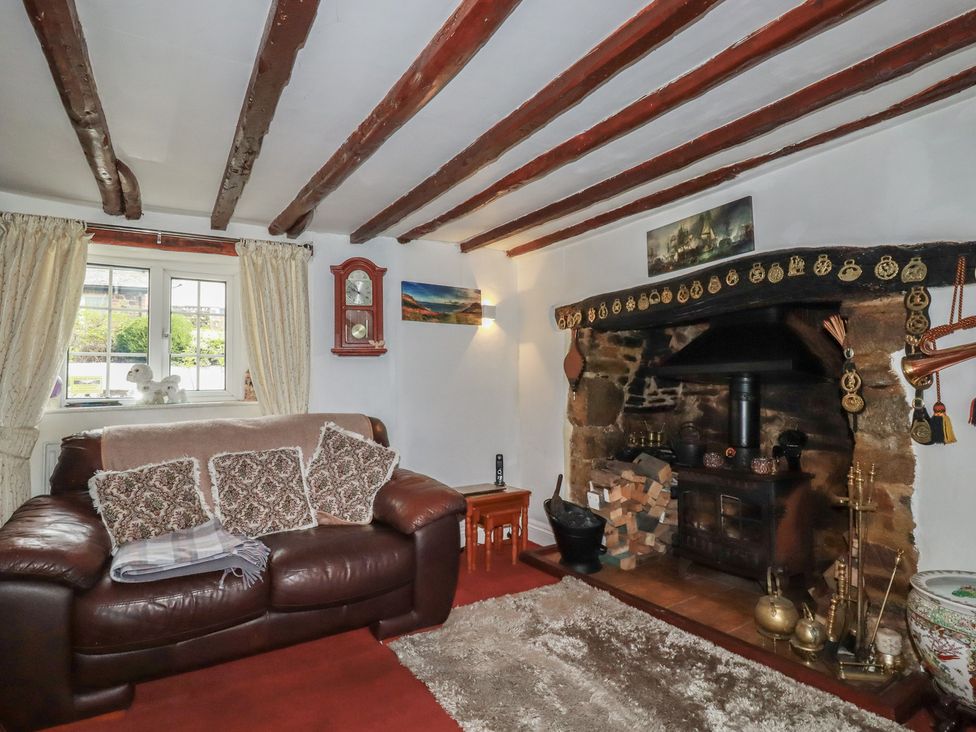 A living room with a fireplace and sofa at Rose Cottage in Launceston