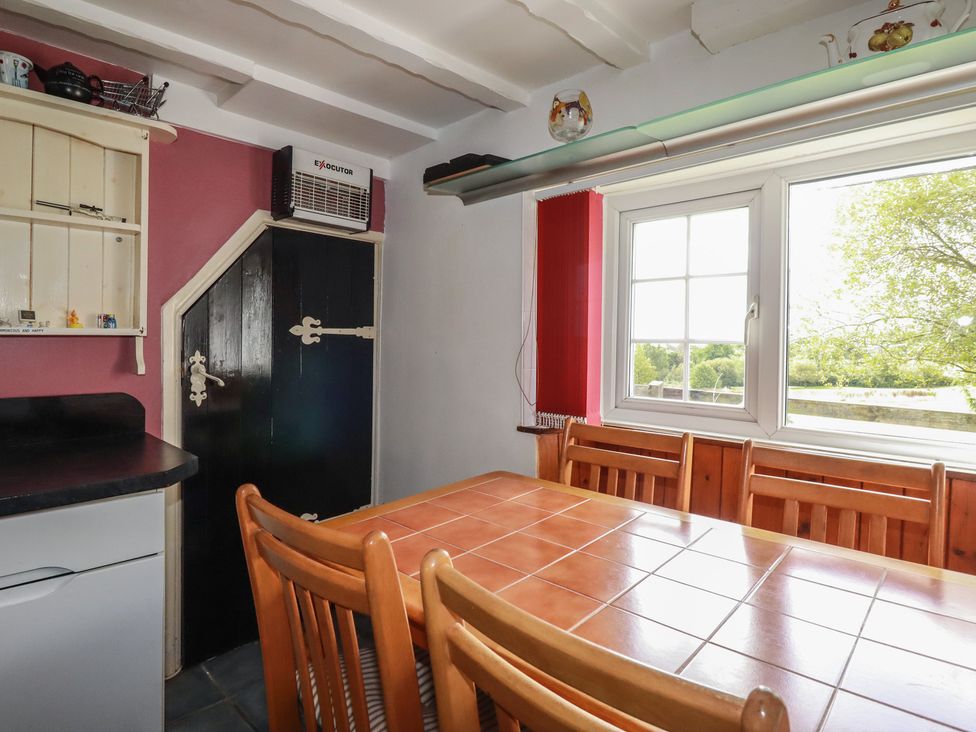 A kitchen with a table and chairs at Rose Cottage in Launceston