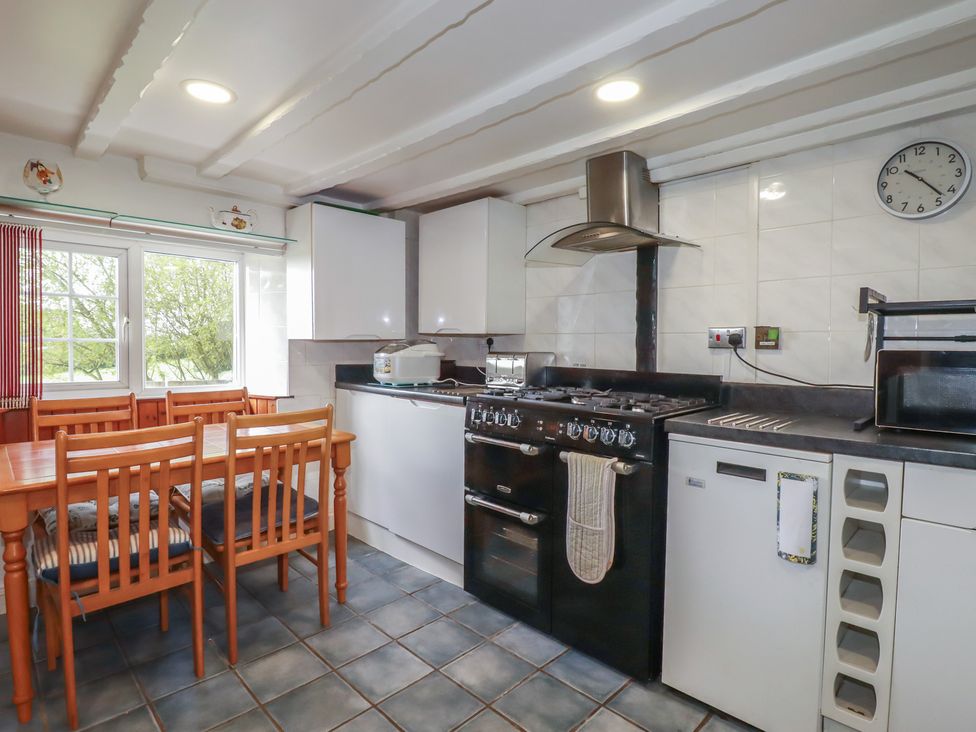 A kitchen with a dining table and chairs at Rose Cottage in Launceston