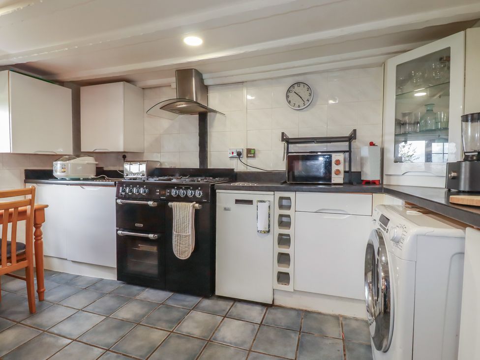 A kitchen with appliances and cabinets at Rose Cottage Launceston