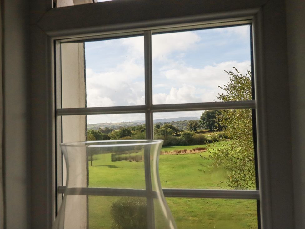 A view from a window featuring a vase and a landscape at Rose Cottage in Launceston