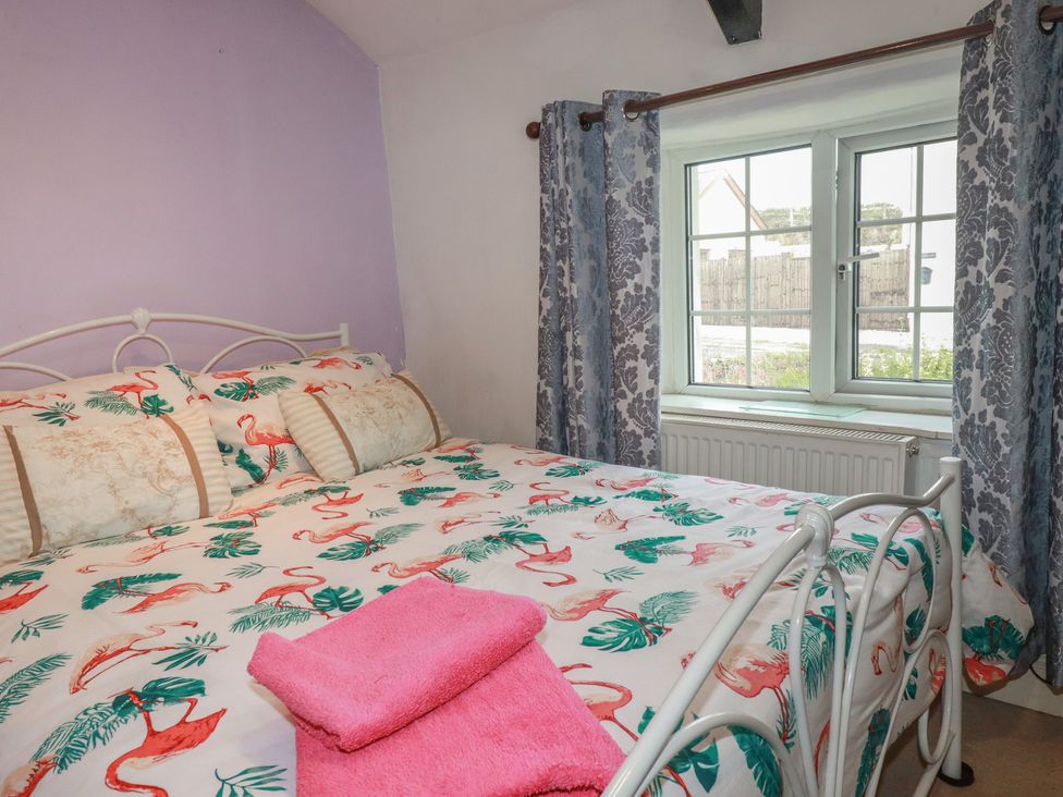 A bedroom with a bed and window at Rose Cottage Launceston