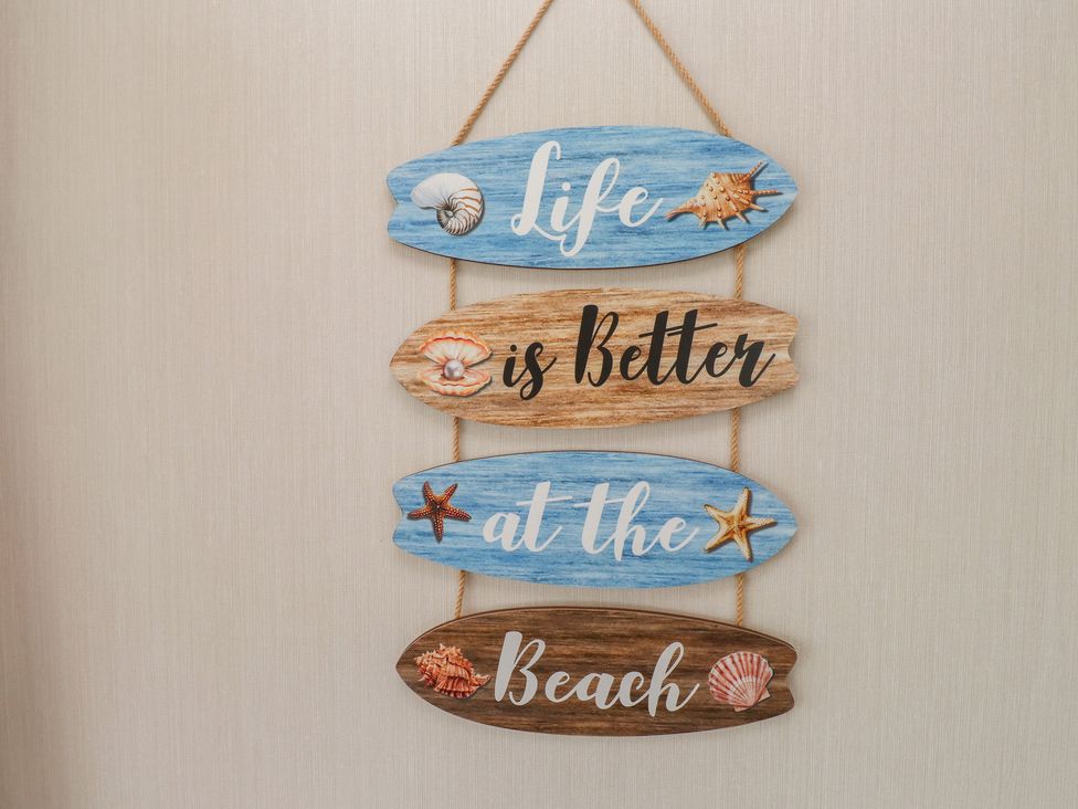 Decorative wooden signs saying Life is Better at the Beach