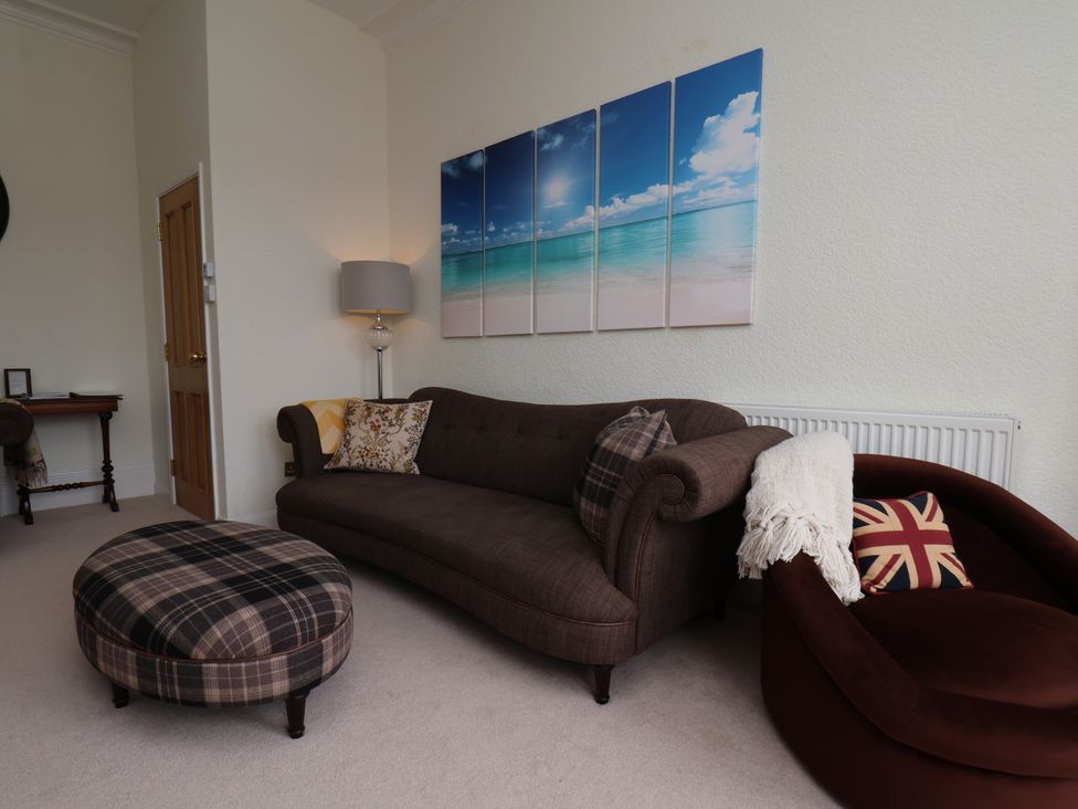 A living room with a sofa and artwork at Sea View Apartment in Whitby