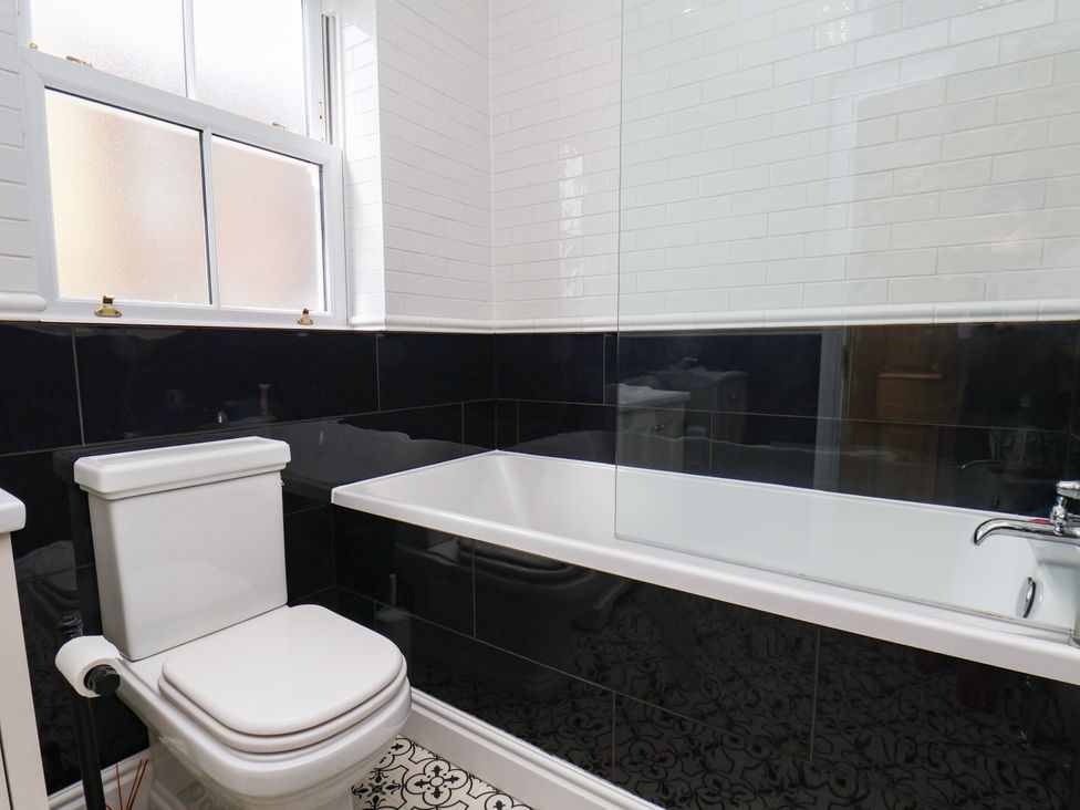 A bathroom with a bathtub and toilet at Sea View Apartment in Whitby