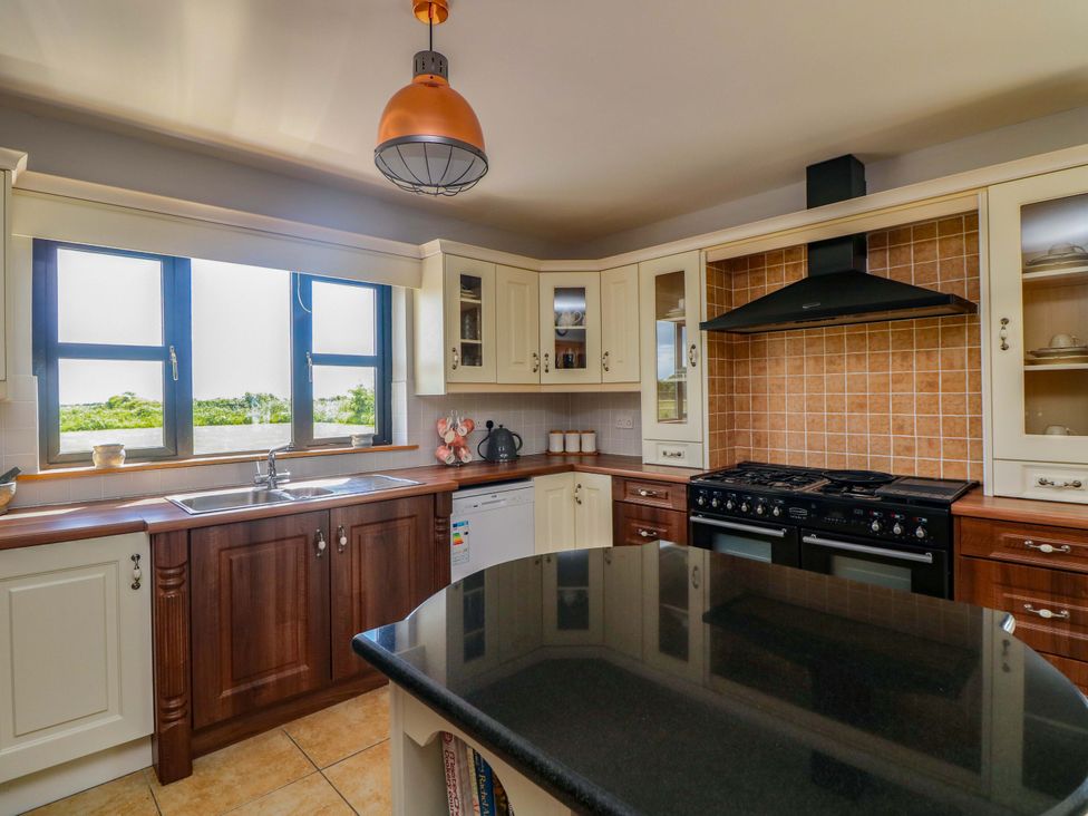 A kitchen with sink and stove at Vernegly in Banonow