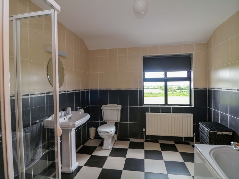 A bathroom with shower and bathtub at Vernegly in Banonow