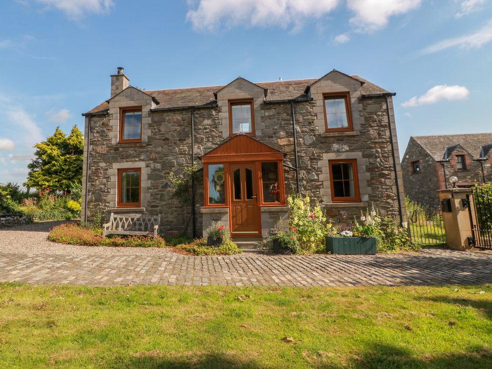 A stone house with a front door and garden at Buchanan’s Bothy in Glencarse