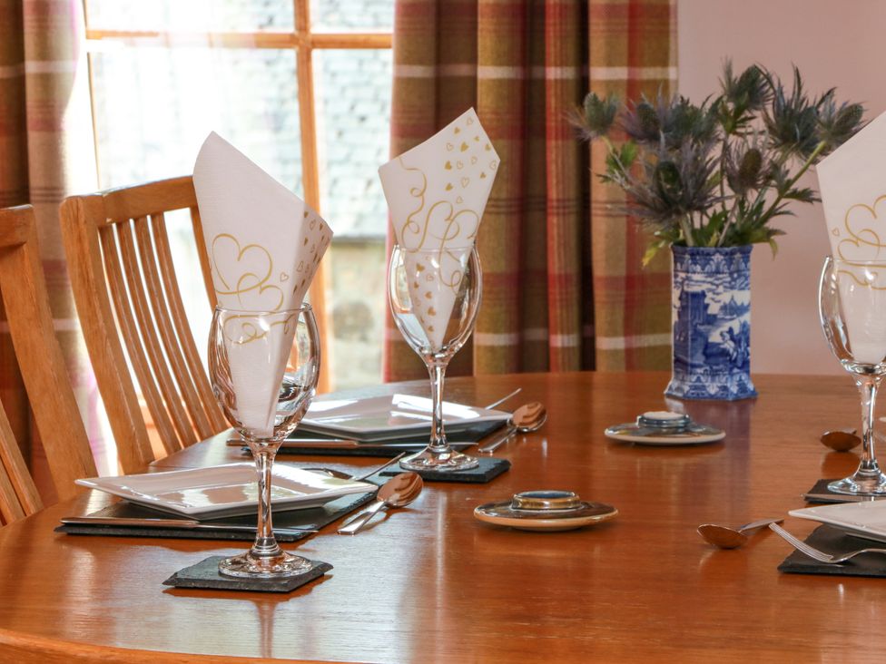 A dining room table set with glasses and napkins at Buchanan’s Bothy Glencarse
