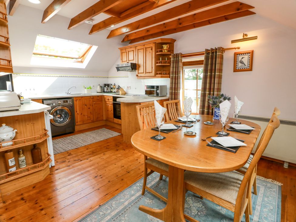 A kitchen with a dining table and chairs at Buchanan’s Bothy in Glencarse