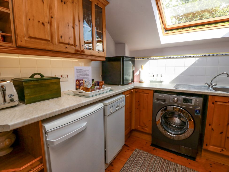 A kitchen with appliances and storage at Buchanan’s Bothy in Glencarse