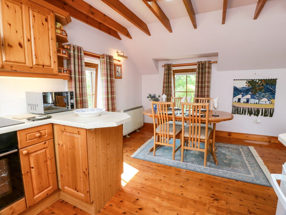 A kitchen with a dining table and chairs at Buchanan’s Bothy in Glencarse