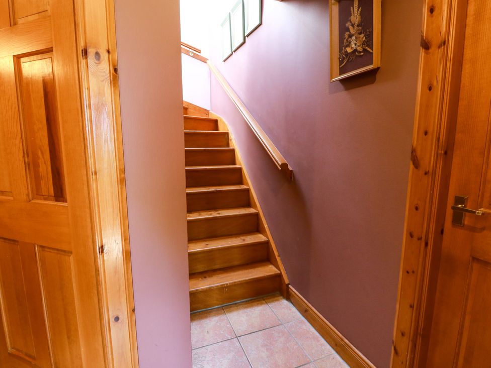 A hallway with stairs leading to the upper floor at Buchanan’s Bothy in Glencarse