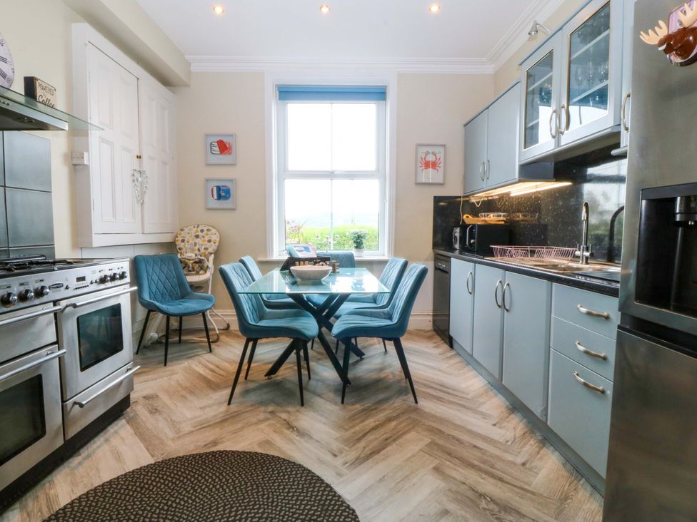 A kitchen with a table and chairs at Jack's House Tywyn
