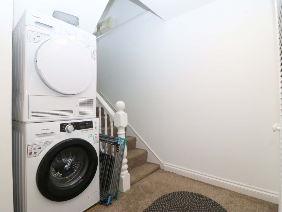 A laundry room with a washer and dryer at Jack's House Tywyn