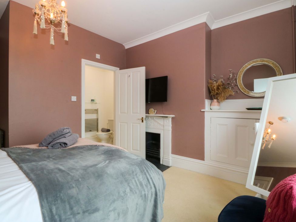 A bedroom with a bed and tv at Jack's House in Tywyn