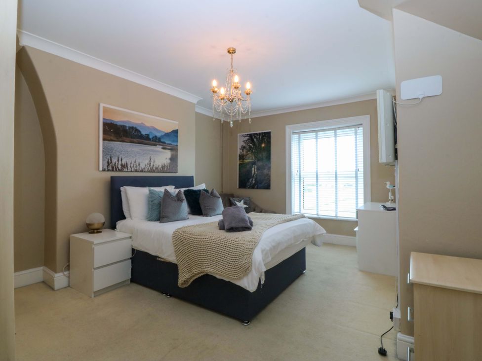 A bedroom with a bed and nightstand at Jack's House in Tywyn