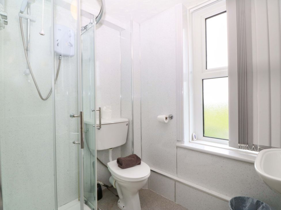 A bathroom with a shower and sink at Jack's House in Tywyn
