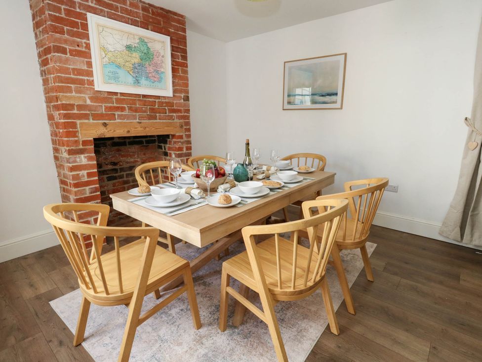 A dining room with table and chairs at The Watch House in Weymouth