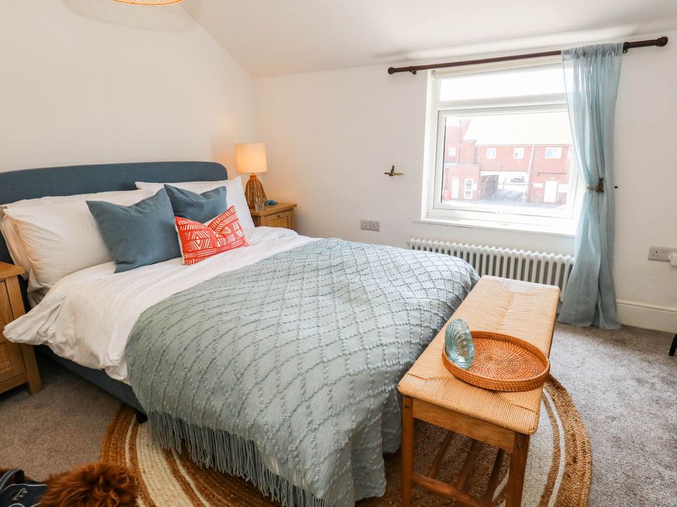 A bedroom with a bed and nightstand at The Watch House in Weymouth