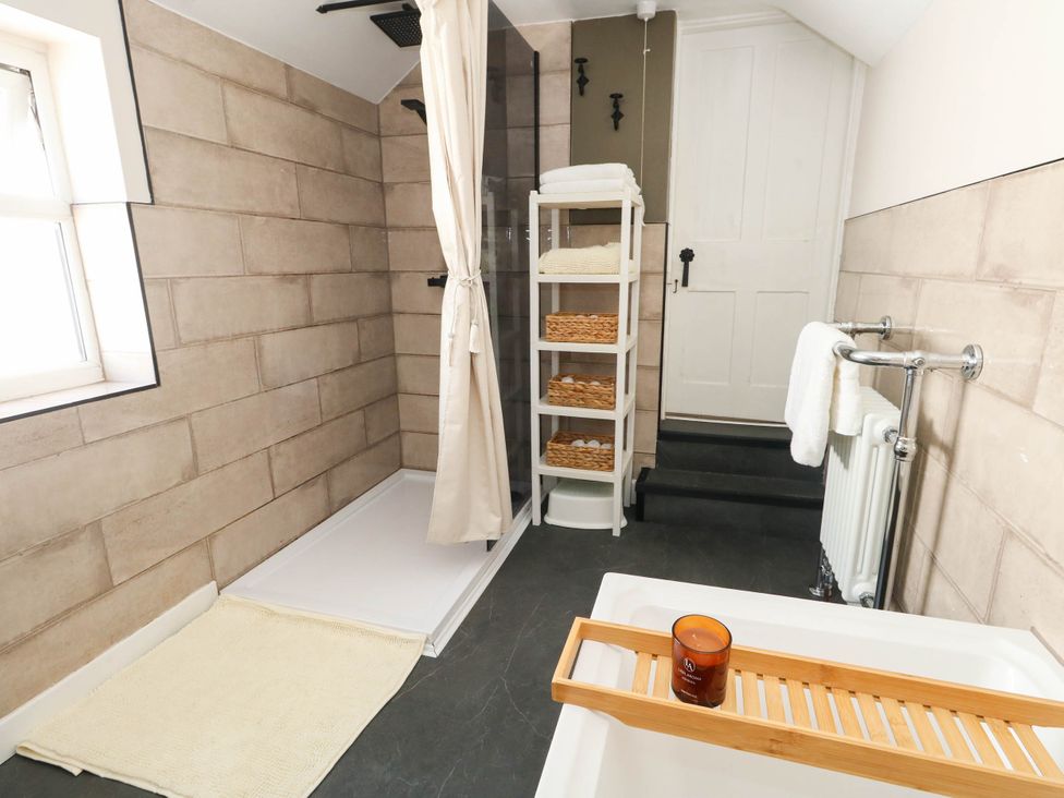 A bathroom with a shower and bathtub at The Watch House in Weymouth