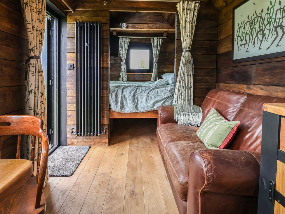 A living room with a sofa and bed at Cloud Cabin