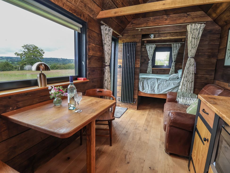 A living room with a table and chairs at Cloud Cabin