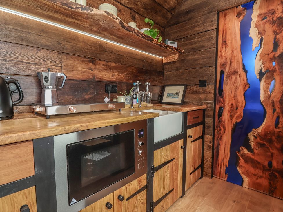 A kitchen with a coffee maker and microwave at Cloud Cabin