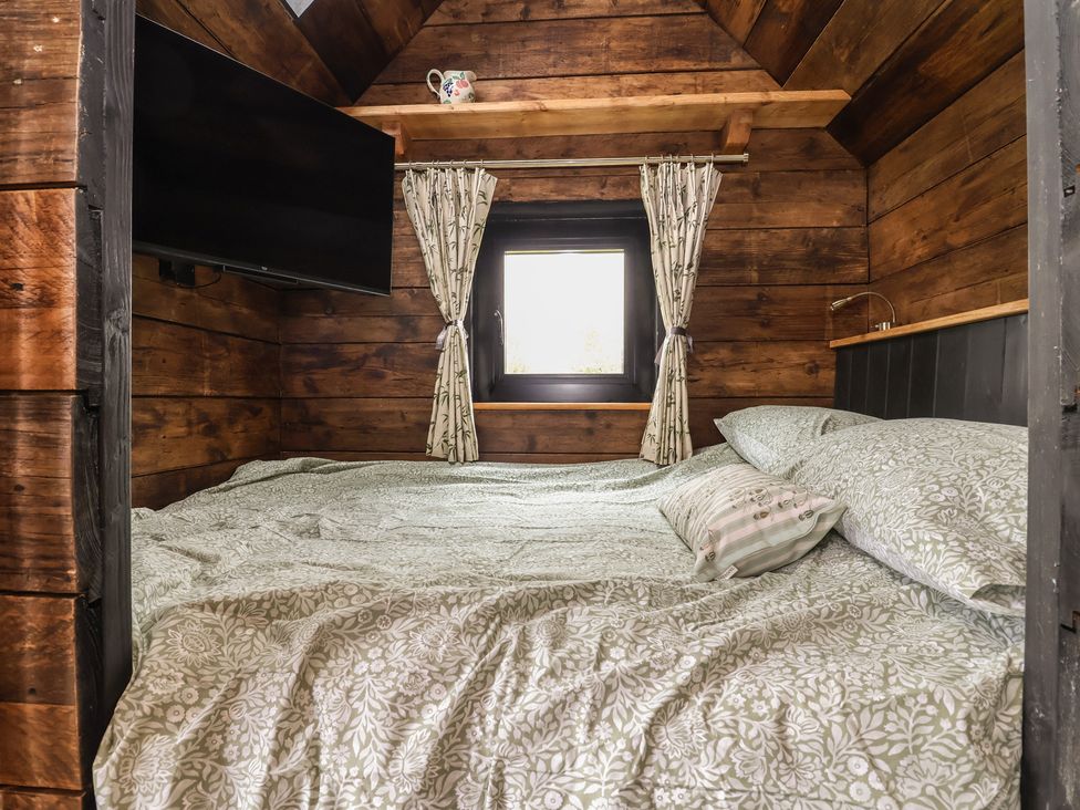 A bedroom with a bed and television at Cloud Cabin