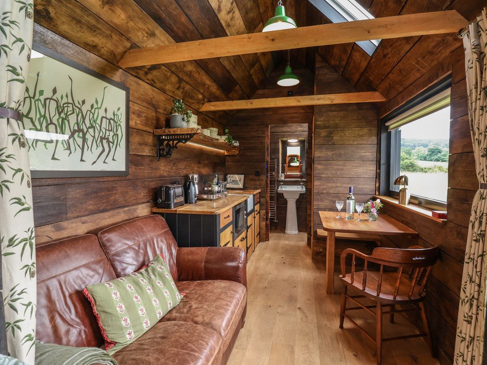 A living room with a sofa and dining table at Cloud Cabin in 