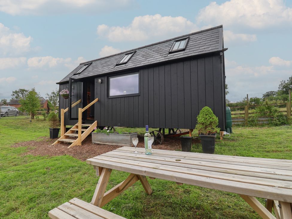A tiny house with steps and outdoor table at Cloud Cabin