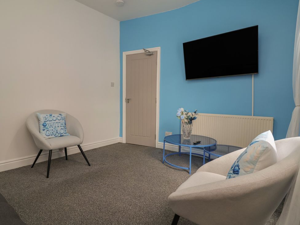 A living room with a television and a coffee table at Lunt Road in Bootle