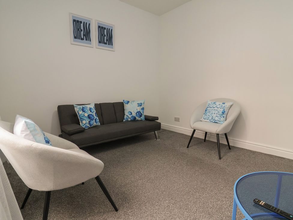A living room with a sofa and armchairs at Lunt Road in Bootle