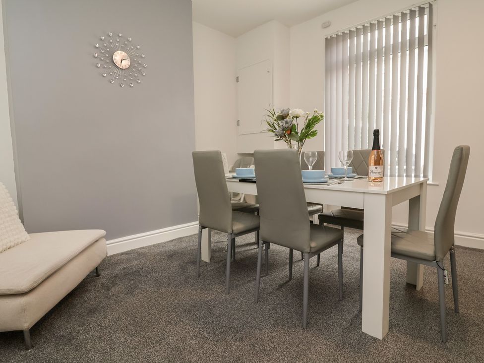 A dining room with a table set for a meal at Lunt Road in Bootle